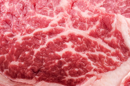 Raw juicy ribeye steak texture. Food background.の写真素材