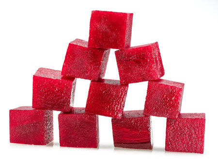 Raw red beetroot cubes arranged as pyramid isolated on white background.の写真素材