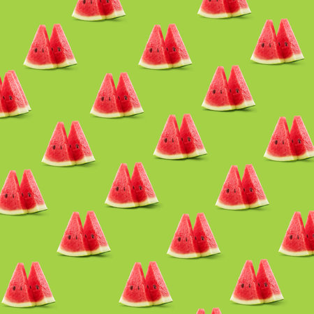 Pattern of watermelon triangle slices isolated on green background.の写真素材
