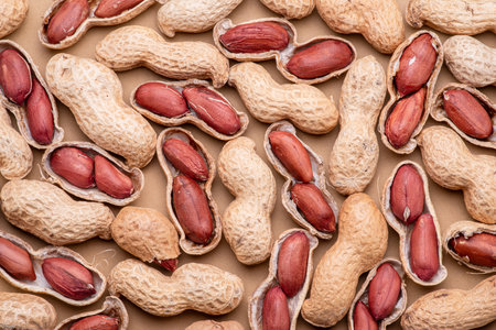 Pile of whole and cracked peanuts close up. Food background.の写真素材