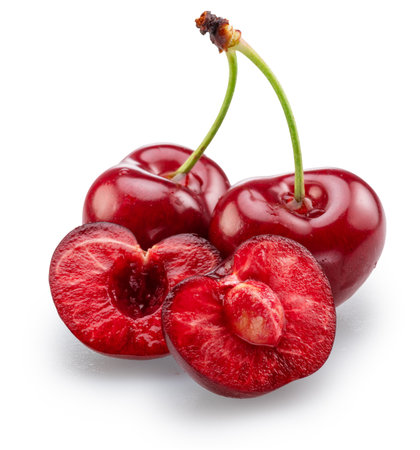 Sweet cherries and half of pitted cherry isolated on white background. File contains clipping paths.の写真素材