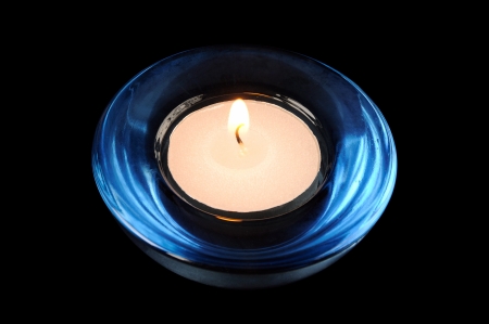 Circular candle on a black backgroundの写真素材