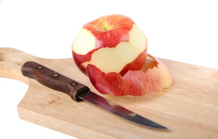 Red apple, peel and knife is on a chopping boardの写真素材
