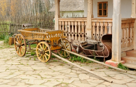 Cart and aged sledge about a porchの写真素材