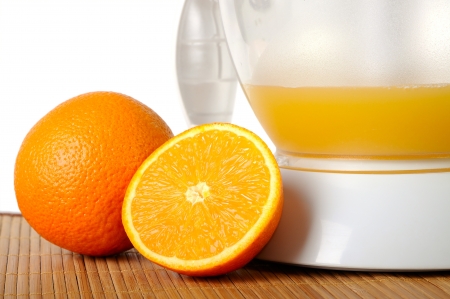Still life with oranges and a juice extractor closeupの写真素材