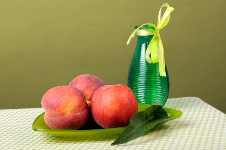 Peaches on a triangular plate and vaseの写真素材