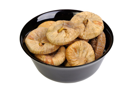 Dried figs in black plate isolated on white backgroundの写真素材