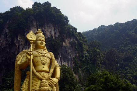 Kuala Lumpur, Malaysia - November 3, 2014:  42-meter statue of Lord Murugan that stands next to the stairs, leading to the top Batu Caves, located in Malaysiaのeditorial素材