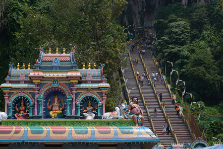 Kuala Lumpur, Malaysia - November 3, 2014: Statues of Hindu gods on the roof of the temple next to Stair, leading to the top Batu Caves - complex of cave hills and Hindu shrines at a distance of 13 km from the center of Kuala Lumpur.のeditorial素材