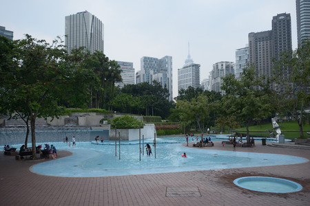 Kuala Lumpur, Malaysia - November 5, 2014: People relaxing in the KLCC Park in Kuala Lumpur, Malaysia. This city park was designed by Brazilian architect Roberto Burle Marx.のeditorial素材
