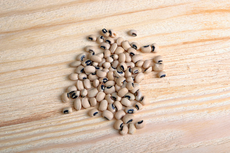 Handful of white beans on a wooden backgroundの写真素材