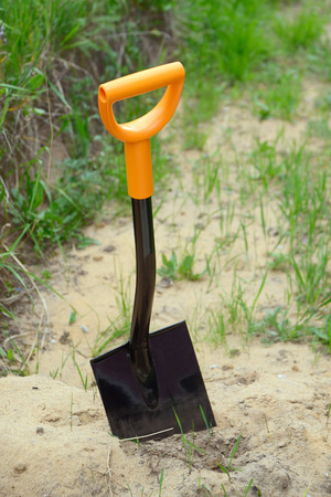 Shovel on heap of sandの写真素材