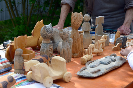St. Petersburg, Russia - May 22, 2016: Vintage wooden handmade toys in folk style on the counter of the fairs.のeditorial素材