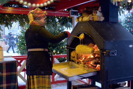 Moscow, Russia - December 25, 2017: Cooking traditional Lithuanian cake of shakotis at the Christmas fairのeditorial素材