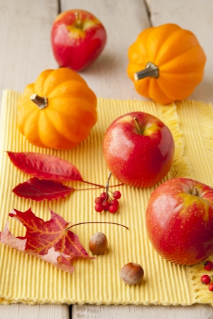 Apples and golden acorn  squash on wood table  sjallow dofの写真素材