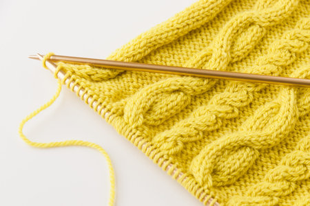 Knitting wool and knitting needles on light background  selective focus