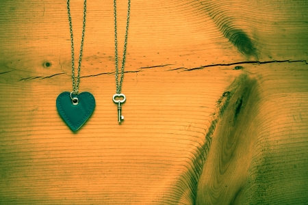 Vintage Valentine,   heart and key on rustic grunge  cracked wood for Valentines day backgroundの写真素材