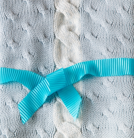 Blue and white knitting wool texture background with ribbonの写真素材