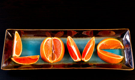 Word  Love  made from   the slices of   cara cara oranges  with its pinkish red color interior 
