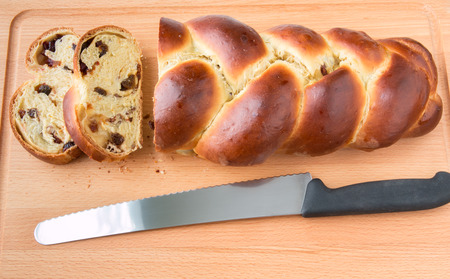 Freshly baked sweet braided bread loaf with fruits and nuts.の写真素材