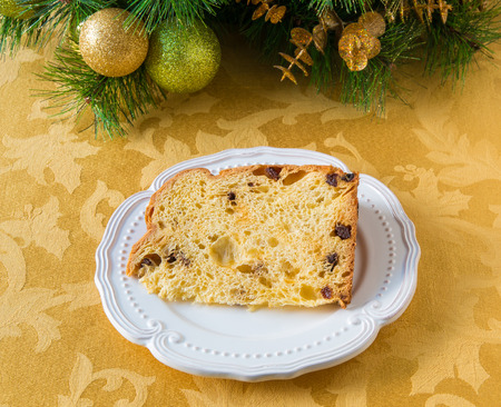 Christmas cake panettone on a plate and Christmas decorations.の写真素材