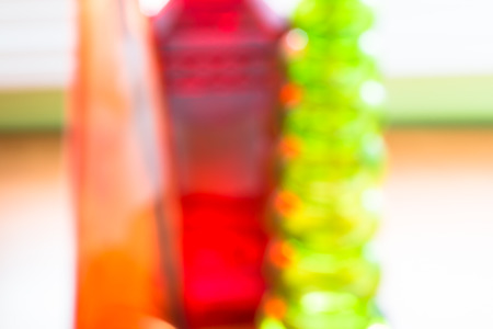 Abstract blurred background, colorful glass bottles against kitchen window.の写真素材