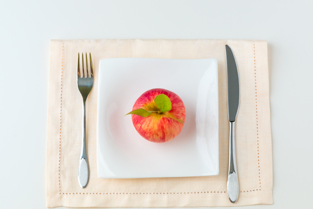 Red apple on a plate. Diet concept.の写真素材