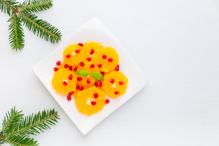 Fresh citrus salad with oranges and pomegranate seeds for winter holiday season with copy space.の写真素材