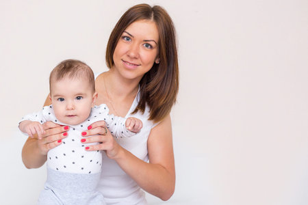 young mother is holding her newborn baby