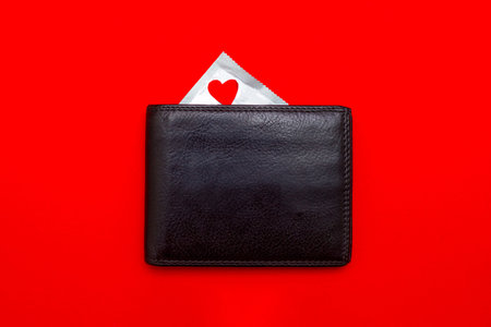 a condom in a wallet. safe sex concept