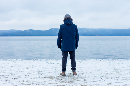 male traveler hiker is at a mountain lakeの写真素材