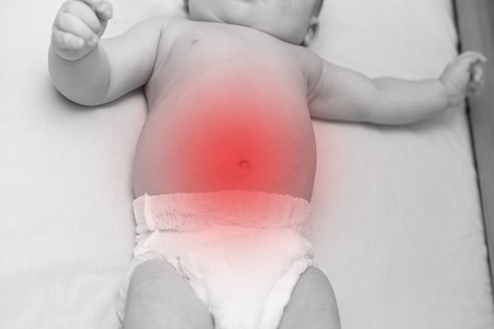 a baby is suffering from a stomachache. pain conceptの写真素材