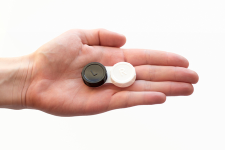 female hand is holding contact lens caseの写真素材