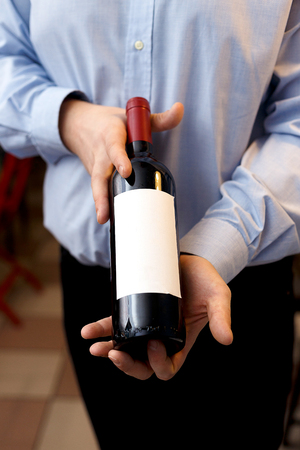 male sommelier is checking and testing red wineの写真素材