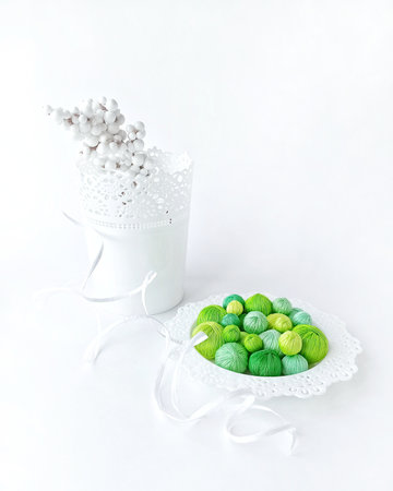 Green threads in a white basket on a white background.の写真素材