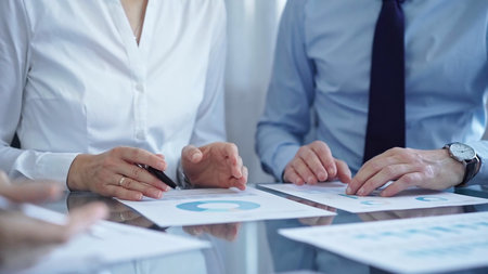Business people are reviewing a financial results and discussing the terms of the agreement....