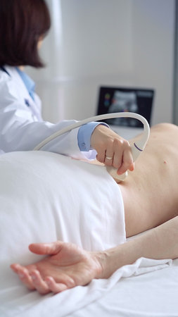 Doctor performing ultrasound examination on patients back