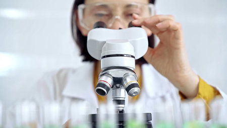 Woman scientist using microscope in laboratory. Microbiology science concept
