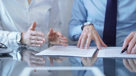 Diverse business people discussing contract papers before signing. Teamwork of lawyers are at work...