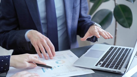 Two professionals analyzing a pie chart during a strategic business meeting. Business meeting with...
