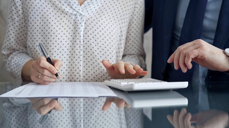 Businesspeople in a meeting with calculator.の写真素材