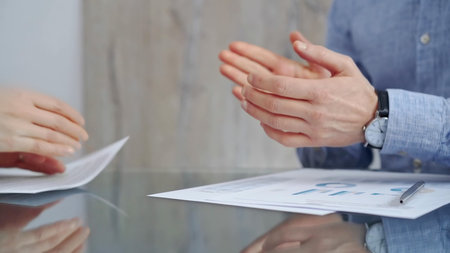 Unrecognizable business people clapping over glass table after contract signing in office. Agreement...