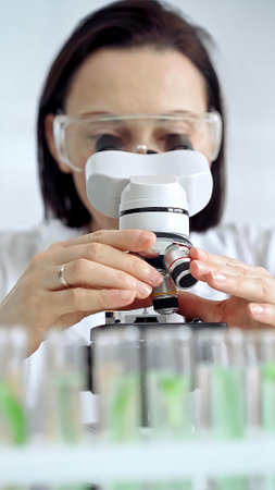 Woman scientist using microscope in laboratory. Microbiology science conceptの写真素材
