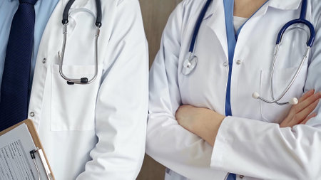 Professional healthcare team in uniform. Two doctors with stethoscopes are standing straight with arms crossed. Medicine conceptの写真素材