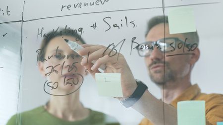 Business professionals reviewing marketing data, sales metrics, and partnership insights on...