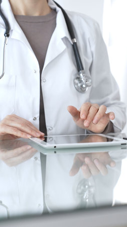 Female doctor uses a digital tablet, provides medical advice and information about health insurance support. Medicine and healthcareの写真素材