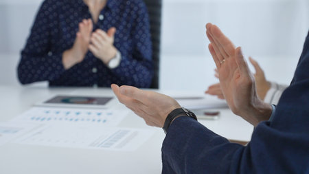 Business team applauding after successful presentation during a meeting in the office, celebrating...