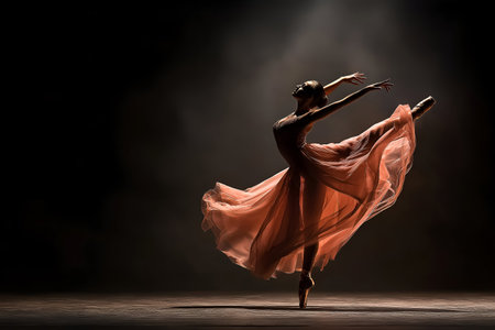 Dancer in an orange flowing dress strikes a graceful pose on stage, surrounded by soft lighting and shadows. Elegance of ballet and the artistry of movement in a captivating performanceの素材