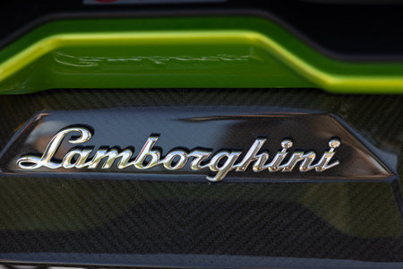 Wroclaw, Poland - June 21, 2025: Close up of Lamborghini chrome emblem on carbon fiber body panel of luxury supercar with green accent detail. Premium automotive brand and performance engineeringのeditorial素材