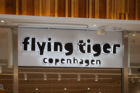 Wroclaw, Poland- October 25, 2025: Flying Tiger Copenhagen retail store logo and illuminated brand...